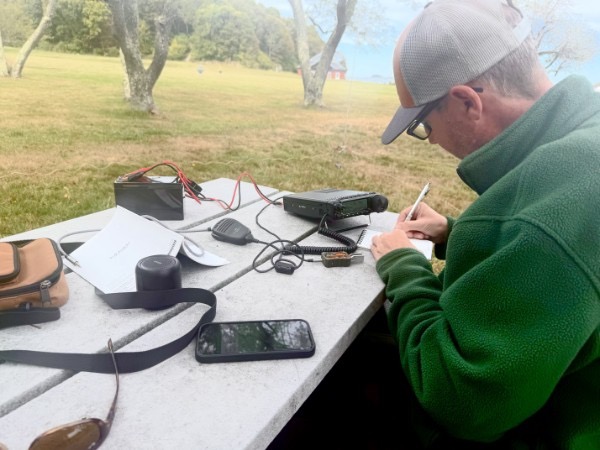 Chris Farnham (W1YTQ) logging a contact by hand next to the FT-891