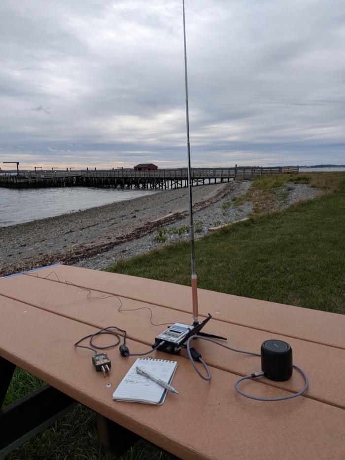 My KH1 set up on a picnic table by the beach, looking out at the pier and the water