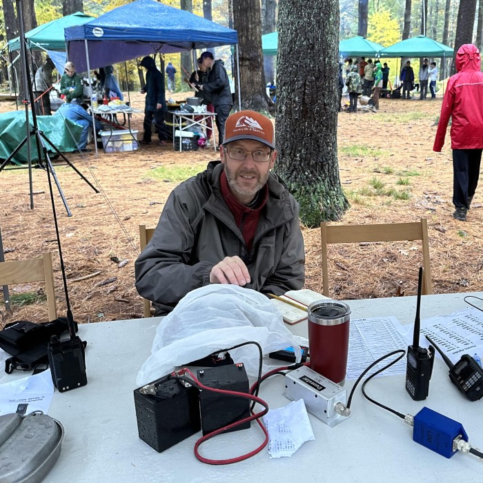 Chris Farnham (W1YTQ) setting up a field radio, preparing to get Scouts on the air for JOTA