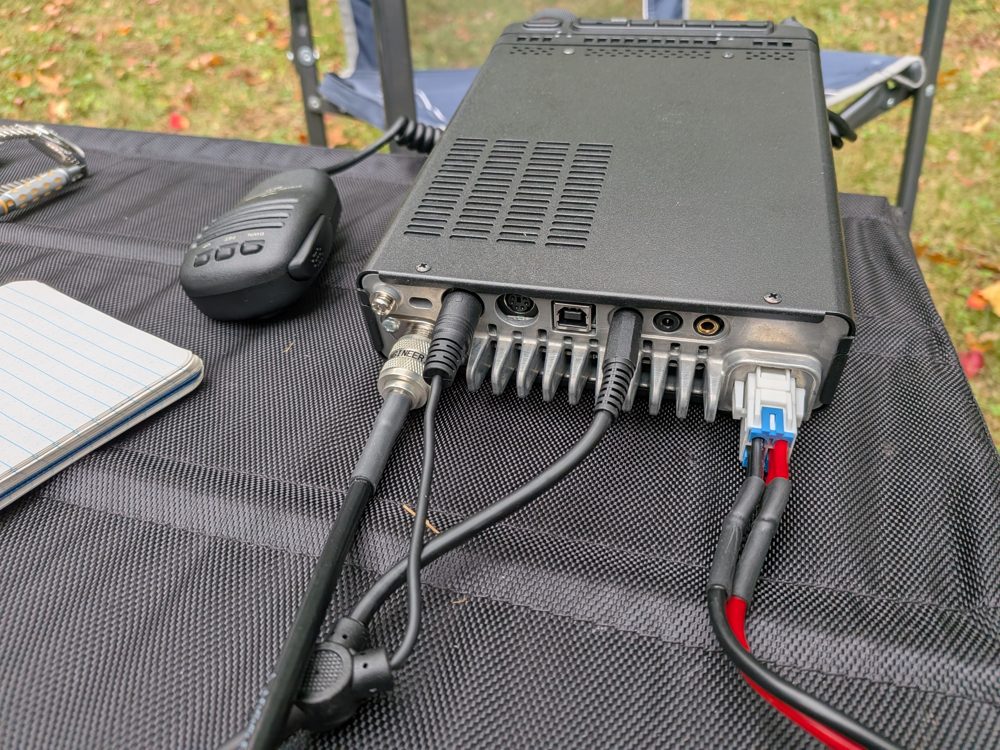 The rear panel of the Yaesu FT-891 with coax, DC power and two other cables plugged in